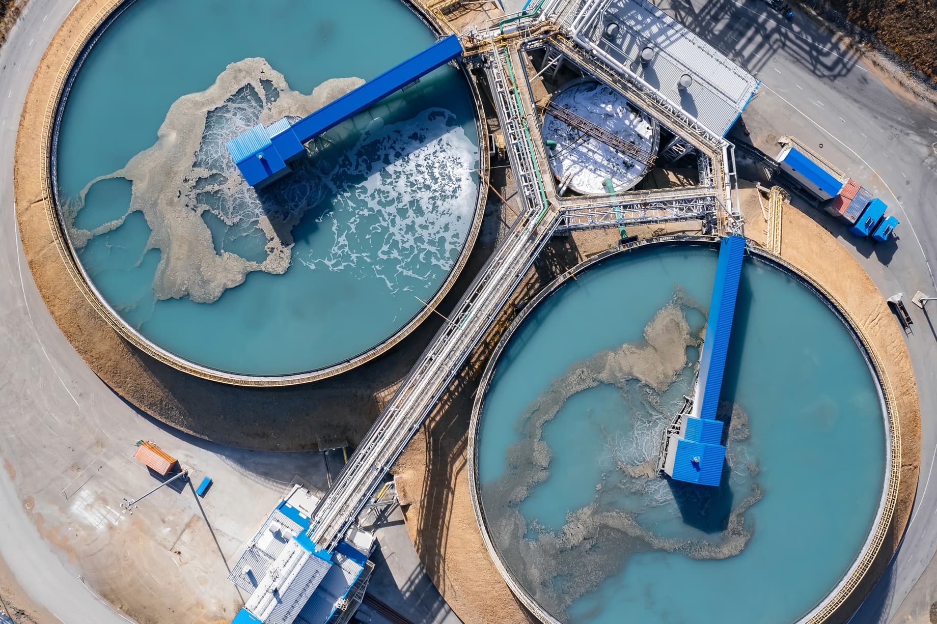 Aerial view of a water treatment facility and processing plant at a copper mine in Latin America, showing the scale of industrial water and energy infrastructure required for sustainable mining operations