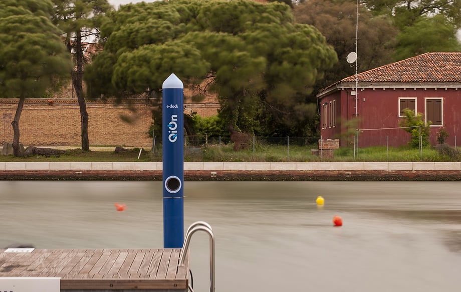 QiOn E-Dock electrified mooring pole standing at a clean marina dock, demonstrating waterfront EV charging infrastructure for electric boats and vessels